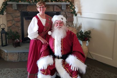 Norma and Jim Levasseur as Mrs. and Mr. Claus with their two grandchildren and dog.