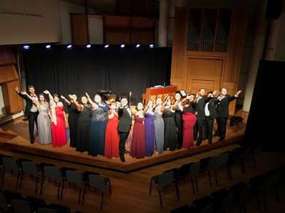 Performers wave from stage after an Opera Workshop performance