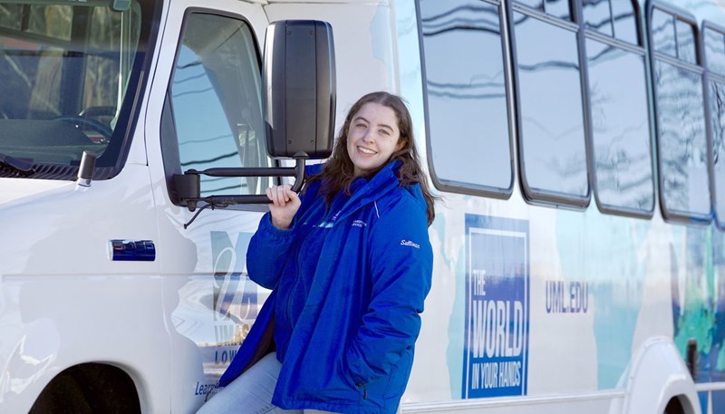 Rachel Sullivan with a campus shuttle