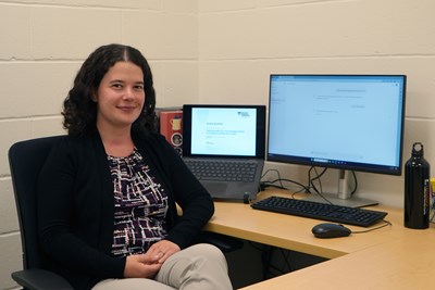 Romy Guthier sits in front of her computers.