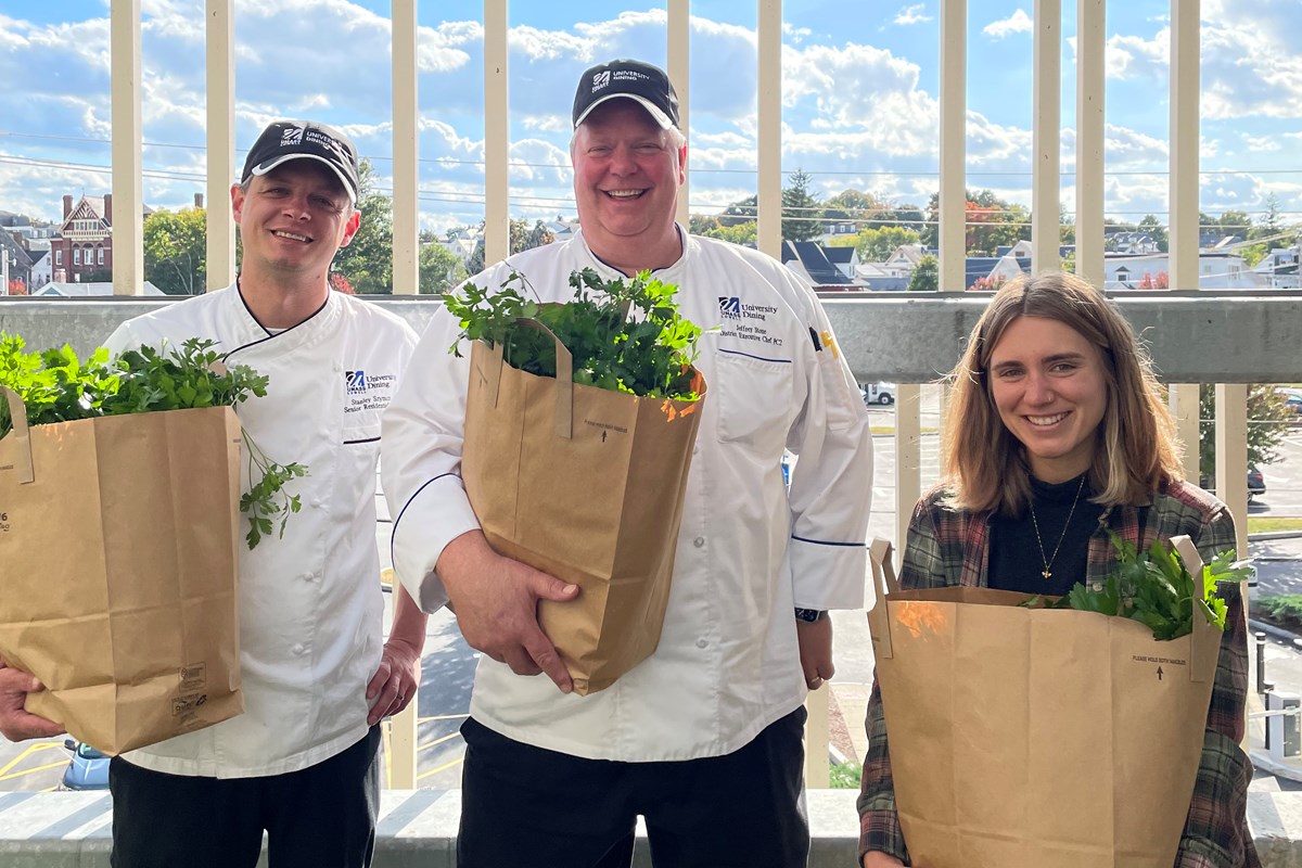 Stanley Szymczak, Jeffrey Stone and Annie Conway hold paper bags filled with parsley.