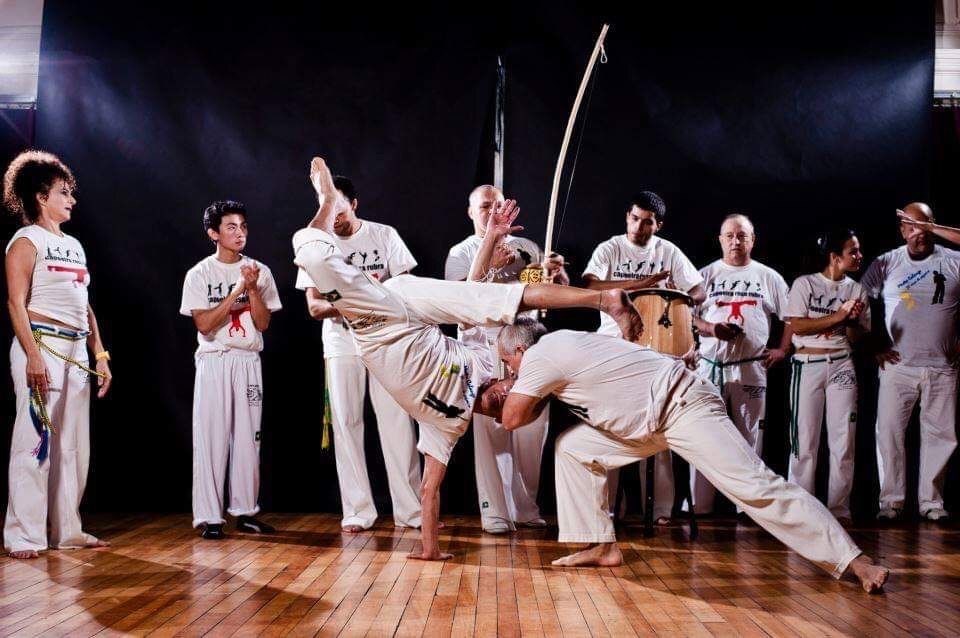 A group of people standing watching Karate Martial Arts demonstration.