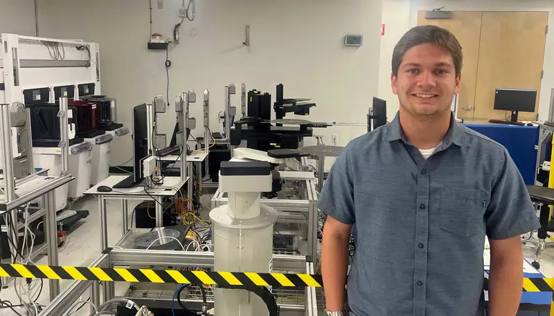 Thomas Warren stands inside a UMass Lowell engineering lab.