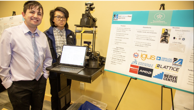 Team TurtleTours standing by their poster presentation at the 2024 $50,000 Idea Challenge.