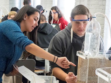 Student with Industrial Watershed Groundwater Tanks