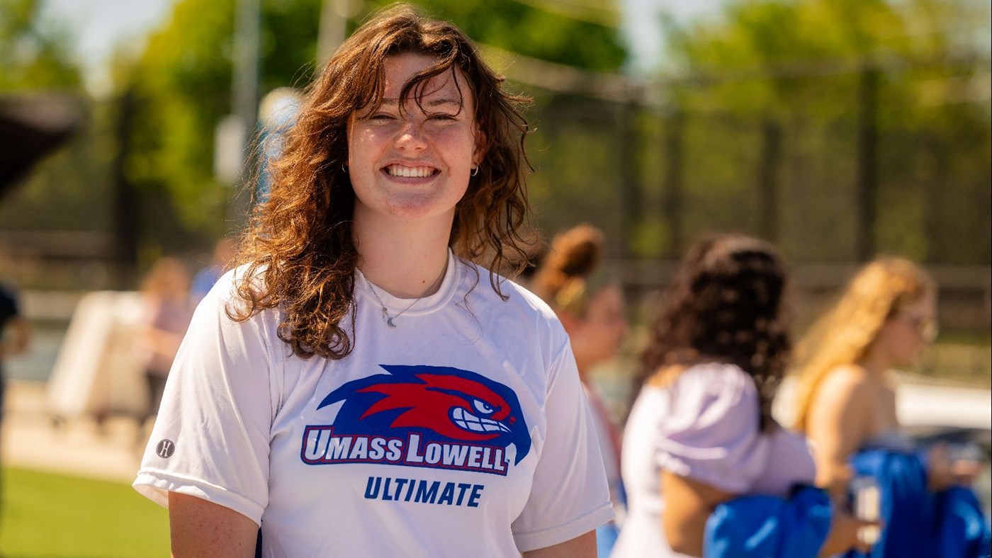 Student wearing Rowdy Riverhawk T-shirt smiling 