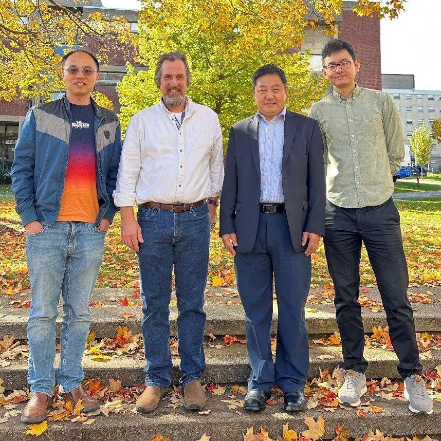 Four members of Biostatistics Group standing under tree