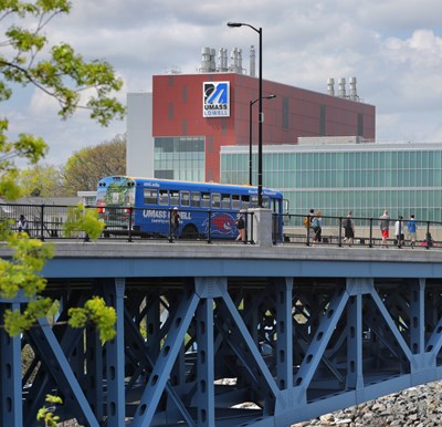 UMass Lowell shuttle bus crossing bridge.