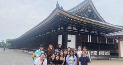 group of students by a typical japanese construction