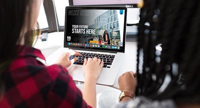 two students viewing umass lowell's digital viewbook on a laptop