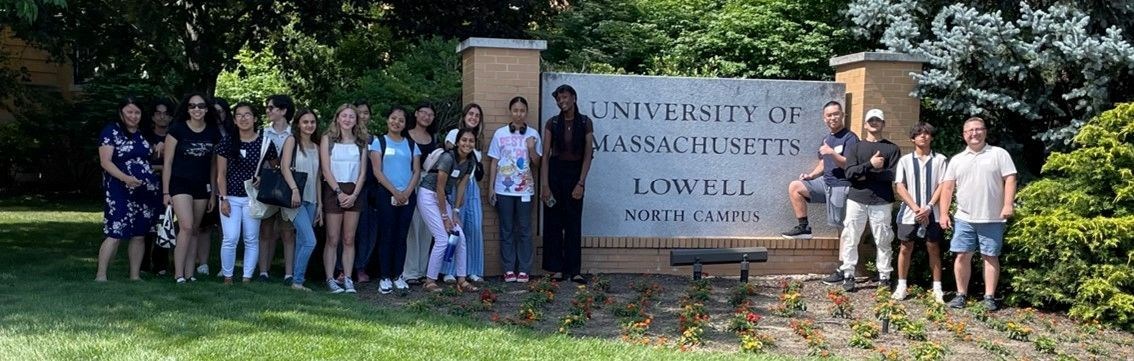 Students from PROPEL program in front of North Campus sign at UMass Lowell