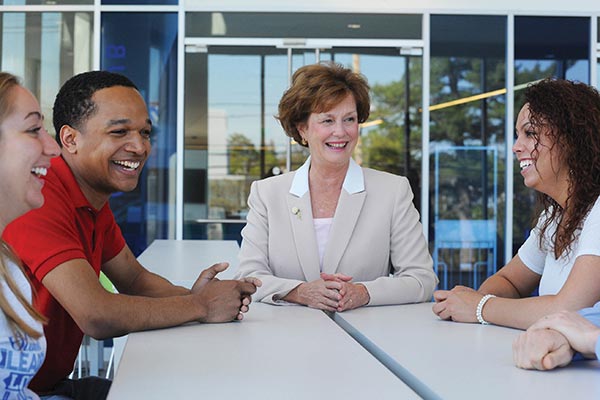 Executive Vice Chancellor Jacqueline Moloney, center, shares a light moment on Commencement Eve with students, from left, Thalia Chodat, Mike Taylor and Kayla Montanez.