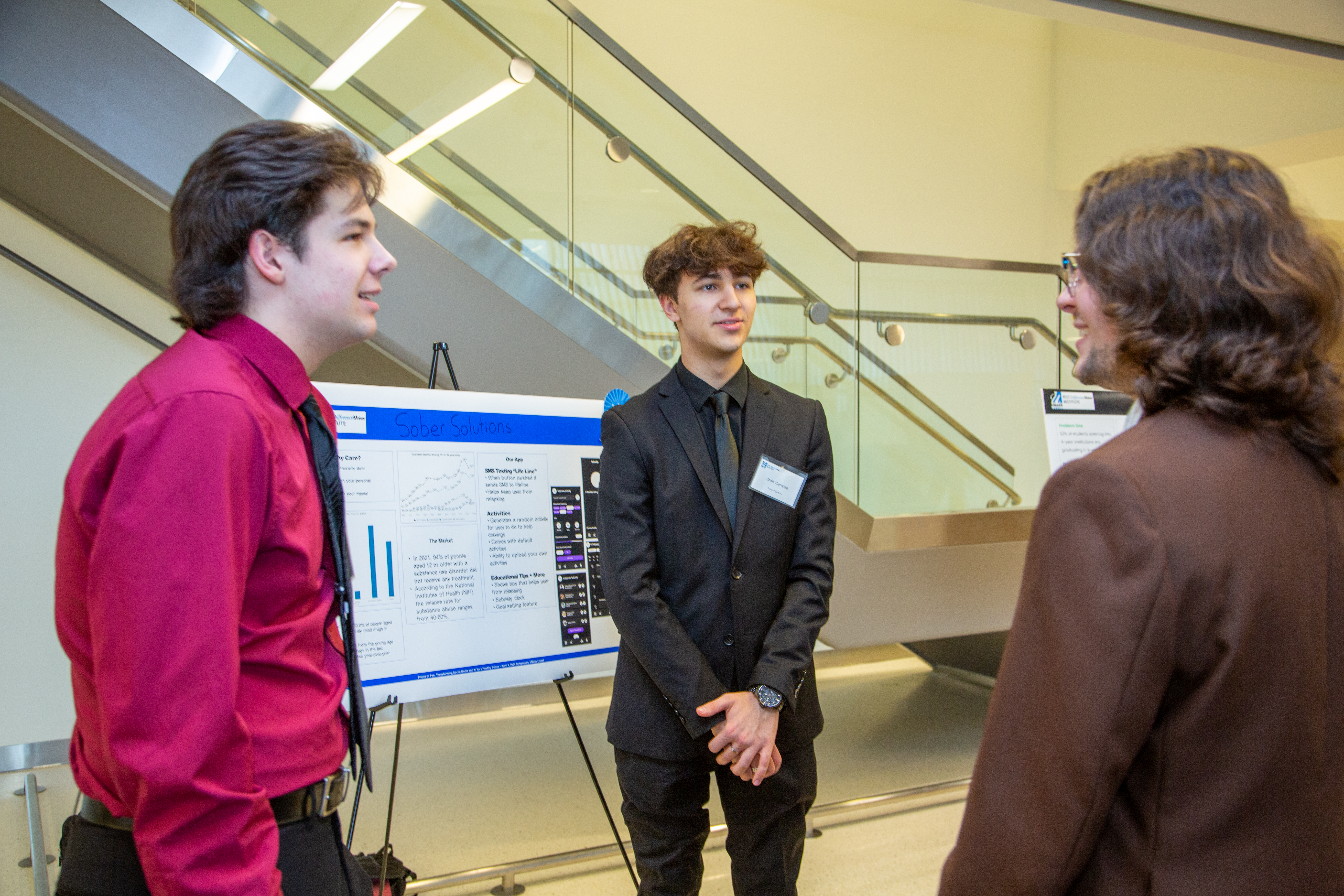 Team Sober Solutions networking with a member of team RAVI at the 2024 $50,000 Idea Challenge.