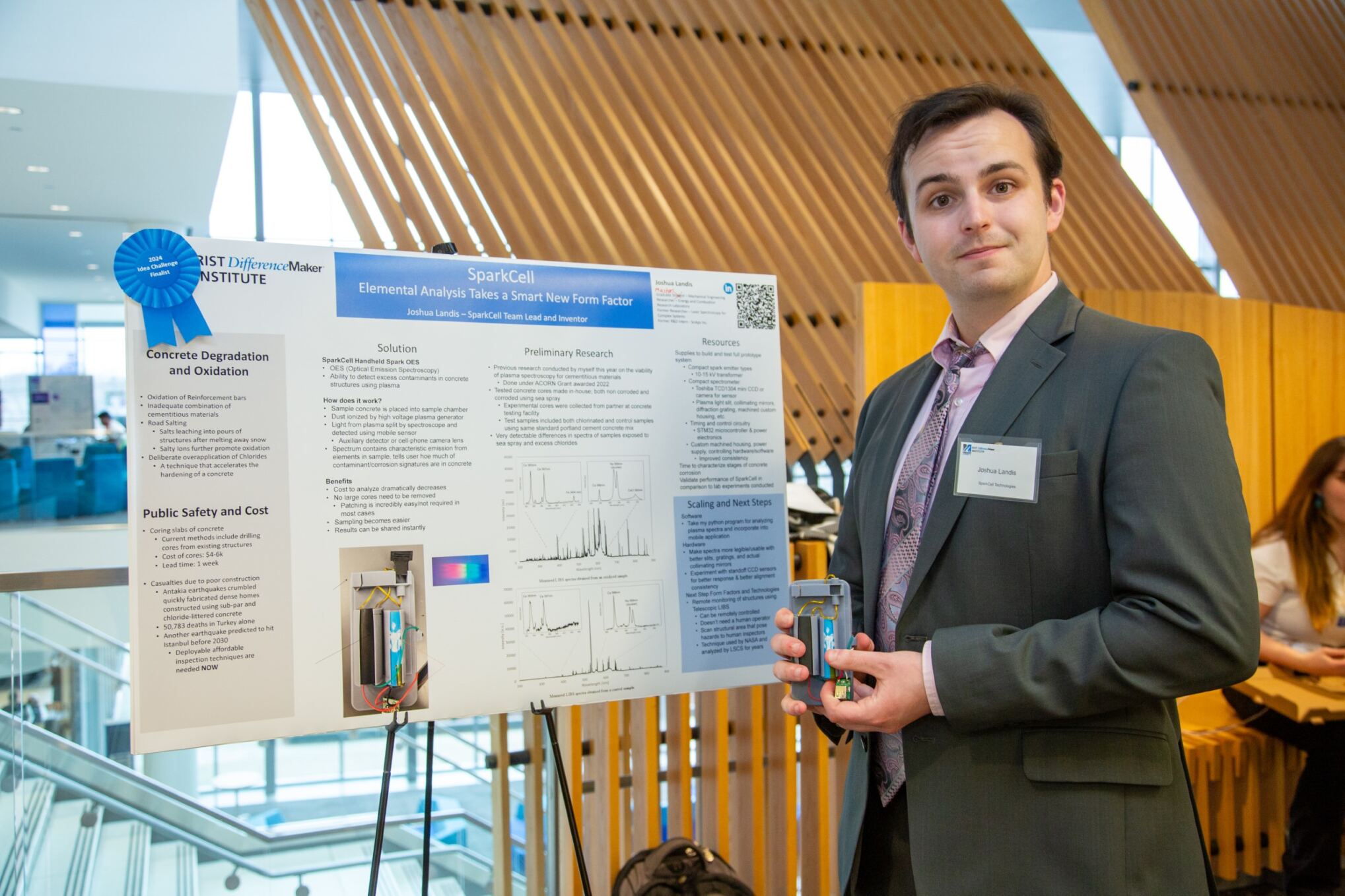 Team SparkCell Technologies standing by their poster at the 2024 $50,000 Idea Challenge.