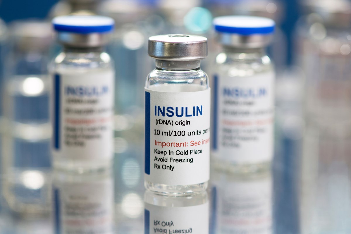 Three main insulin vials with one in focus.