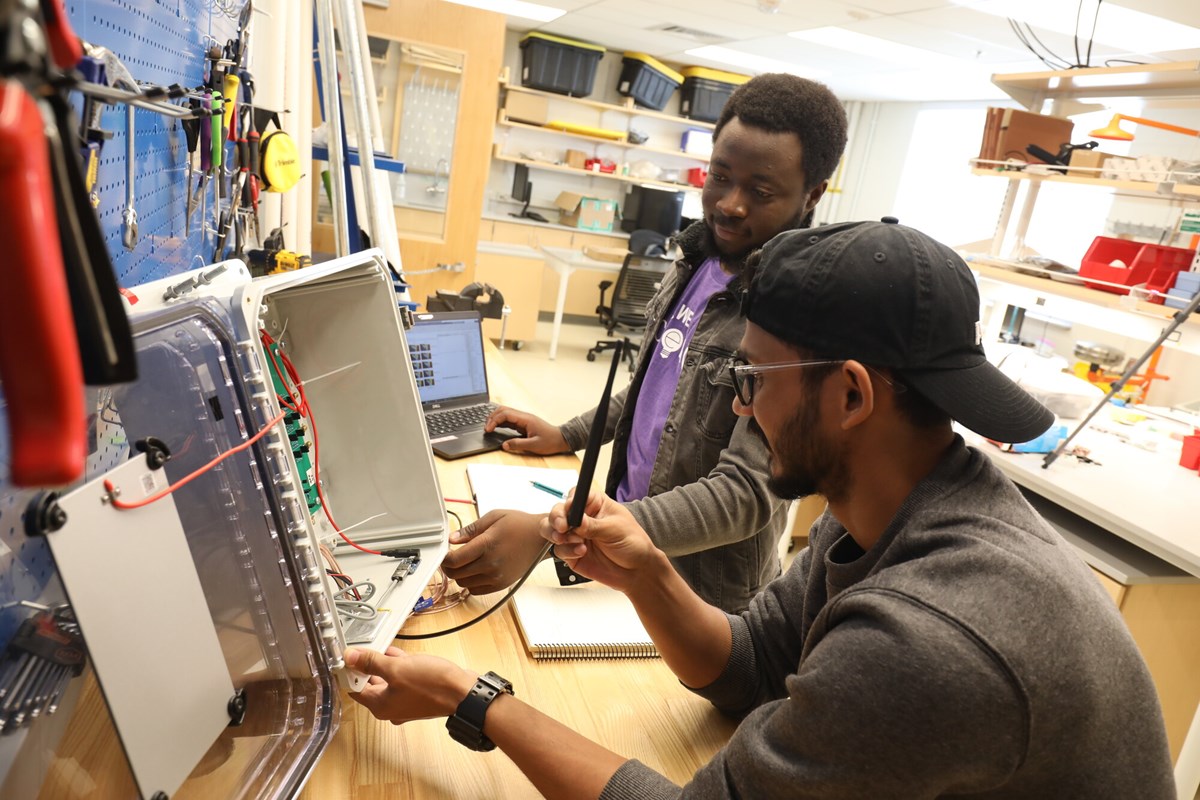 two young men work on wiring project