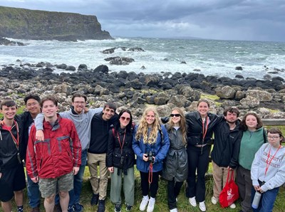 UMass Lowell Study Abroad students pose at a beach in Belfast, Ireland in Summer 2024.