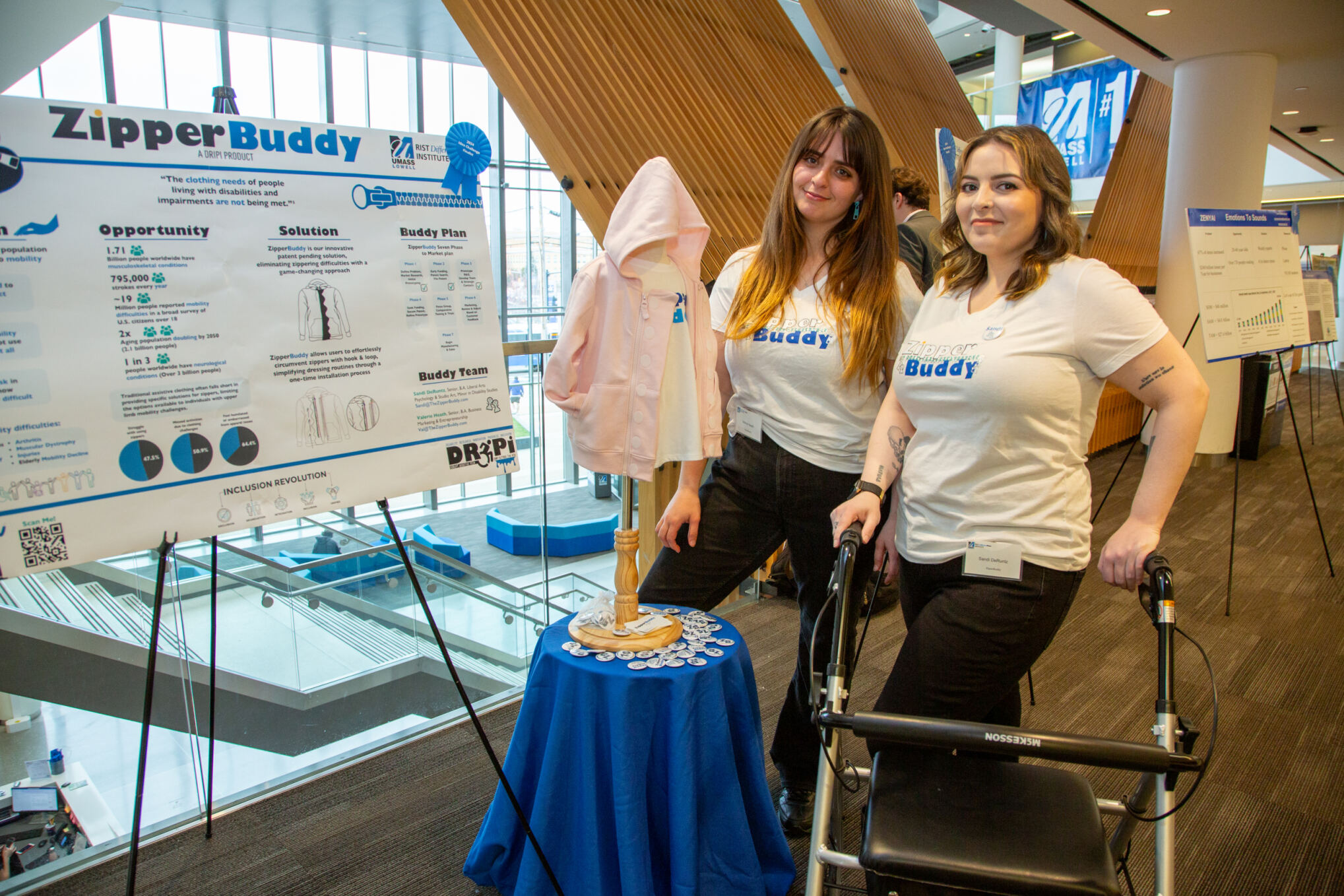 Team ZipperBuddy standing by their poster presentation at the 2024 $50,000 Idea Challenge.